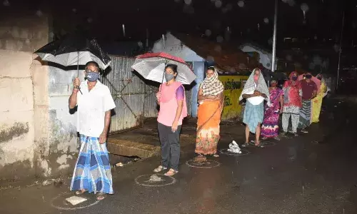 ஈரோட்டில் தடுப்பூசி போட ஆர்வம் - கொட்டும் மழையில் குடையுடன் காத்திருந்த மக்கள்