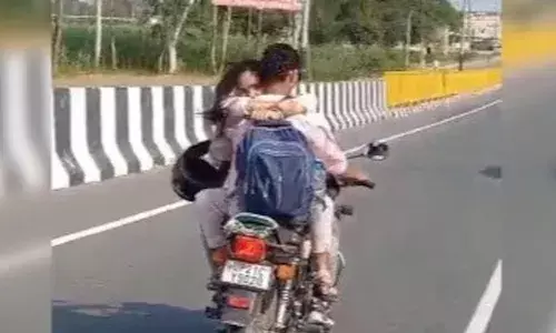 Couple Hugging While Riding Bike, கட்டிப்பிடித்தபடி  பைக்கில் சென்ற உ.பி தம்பதிக்கு ரூ.8,000 அபராதம்